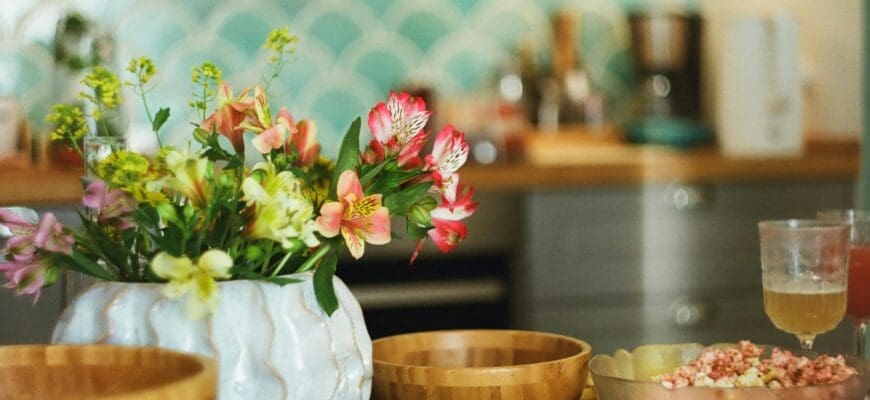 Kitchen Table with Multiple Wooden Bowls and a Round Vase with Flowers